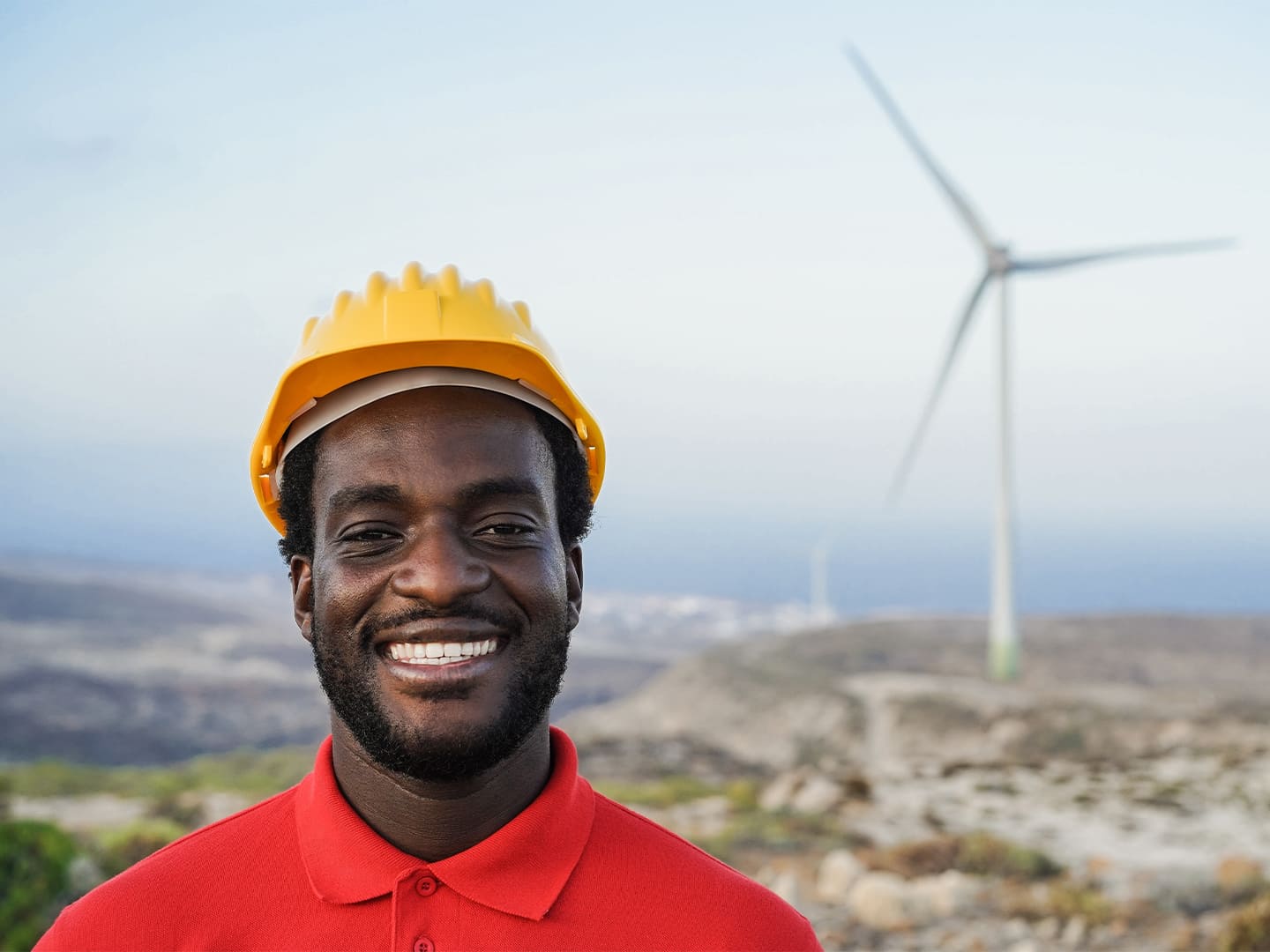 Man in front of a wind turbine